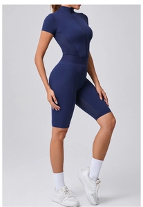 Detail view of the breathable mesh splicing on a dark blue zip-up yoga jumpsuit