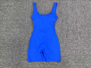 Detail shot of royal blue sports bodysuit showing seamless v-waist cut and stretch fabric