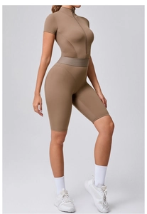 Detail of zippered yoga bodysuit with breathable mesh panels and slim fit waist