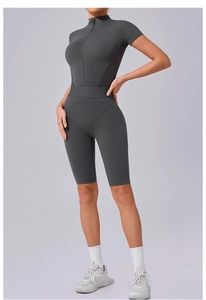 Close-up of the front zipper and high-neck collar on this slim fit dark grey yoga romper