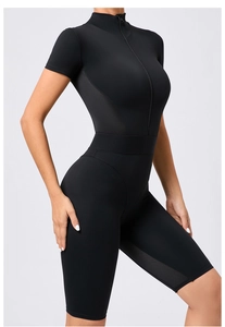 Close-up of black short sleeve yoga jumpsuit with mesh splicing and front zipper detail