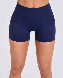 Detail of navy high-waisted yoga shorts showing functional side stitching and elastic fabric