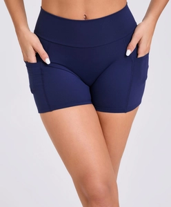 Detail view of high-waisted navy yoga shorts with deep side pockets and smooth seams