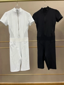 Detail showing mesh panels and front zippers on black and white yoga bodysuits