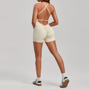 Macro detail of scrunch butt seam and cross back straps on beige yoga bodysuit
