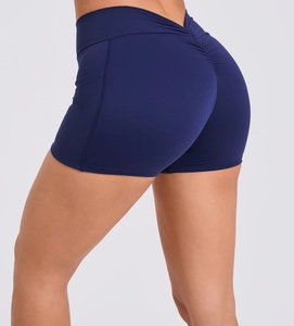 Detail showing high-waisted navy blue yoga shorts with V-shaped waist and scrunch butt design