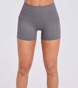 Detail view of high waisted yoga shorts with side pockets and fine stitching in grey