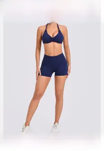 Detail of navy blue high-stretch yoga set with cross-back sports bra and side pocket shorts