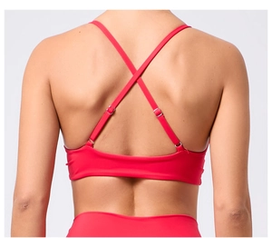 Détail du soutien-gorge de sport rouge avec bretelles croisées et boucles en métal réglables