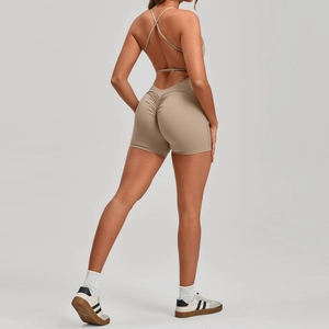 Detailed back view of khaki scrunch yoga romper featuring cross straps and open back design