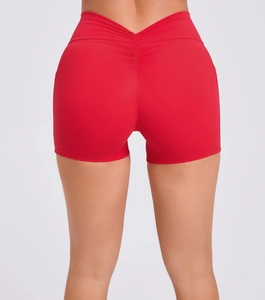 Detail view of the red scrunch butt yoga shorts with V-shaped high waist design