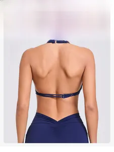 Detail of navy blue yoga top with adjustable cross straps and silver buckle on the back