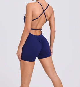 Detail of navy blue backless yoga bodysuit with cross straps and ruched butt lifting effect