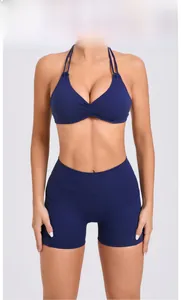 Detail of navy blue high-waist yoga shorts with side pocket and racerback sports bra