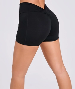 Detail of high waist black yoga shorts with side pocket and scrunch butt design