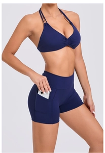 Detail view of high-waist yoga shorts with functional side pocket for mobile phone storage