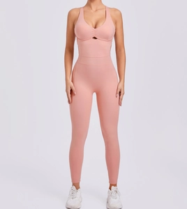 Detailed front view of pink V-neck yoga jumpsuit with cutout and pleated chest design