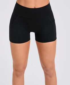 Close-up of high-waisted black yoga shorts with side pockets and slimming elastic fabric
