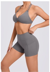 Detail of grey yoga set featuring adjustable halter neck bra and side pockets on shorts
