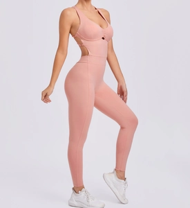 Detail view of pink-orange yoga bodysuit featuring side cut-outs and V-neckline