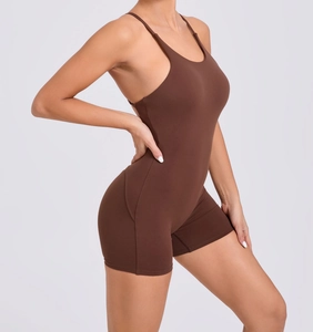 Detail of cross-back straps and moisture-wicking fabric on brown yoga bodysuit