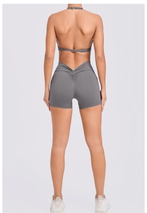 Detail view of the halter neck open-back sports bra and high-waist scrunch booty shorts