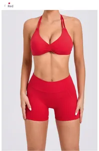 Detail view of red yoga set featuring halter neck sports bra and high-waisted shorts