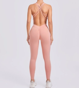 Detailed back view of pink yoga jumpsuit with cross-back straps and scrunch butt design