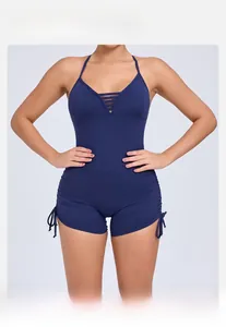Detail of dark blue yoga bodysuit featuring cut-out neckline and side drawstrings