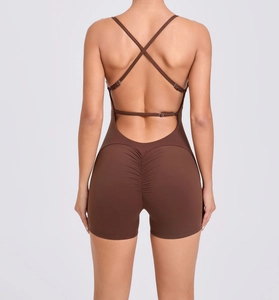 Detail of dark brown yoga jumpsuit featuring cross-back straps and ruched butt lifting design