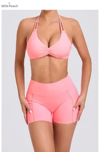 Detailed view of wild peach yoga set featuring ruched sports bra and high-waisted shorts