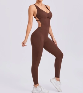 Detail view of the brown yoga jumpsuit showing side cut-outs and elastic fabric