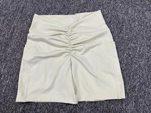 Detail of high waist cream yoga shorts featuring scrunch butt design and side pockets