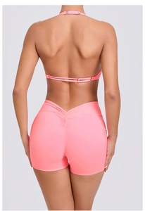 Detail of coral pink halter top with metal buckle and ruched butt-lifting shorts