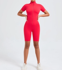 Close-up of bright red athletic romper featuring front zipper closure and stretchy fabric