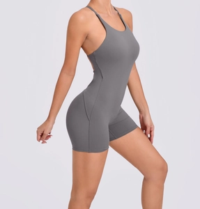 Detail of grey backless yoga jumpsuit with thin straps and elastic bodycon fit