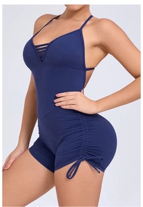 Detail of navy blue yoga bodysuit featuring side drawstring ruching and halter neck