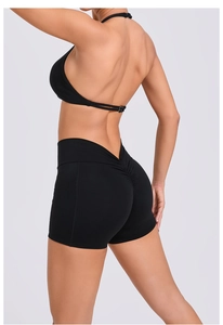 Detail of high-waisted black yoga shorts with V-shaped waistband and scrunch butt design