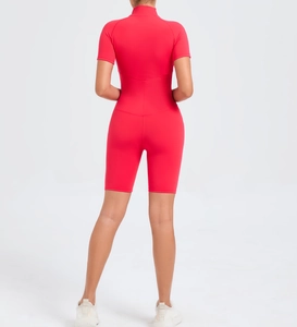 Back view of a red short-sleeved compression yoga bodysuit with high collar and sleek fit