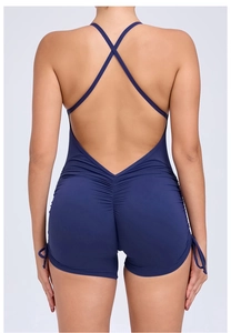 Detail view of navy blue backless yoga jumpsuit with crisscross straps and side drawstrings