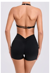 Detail view of black yoga set featuring ruched bum shorts and V-shaped high waistband