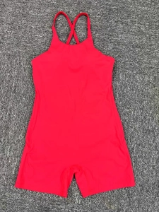 Close-up of red athletic bodysuit showing cross back straps and stretch fabric detail