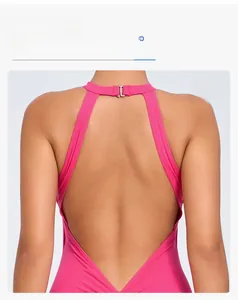Pink backless yoga bodysuit featuring halter neck metal buckle and deep V cut detail