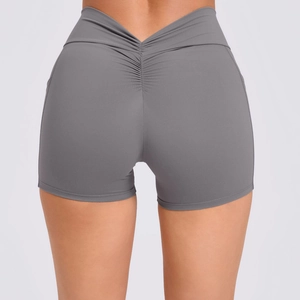 Dark gray high waisted scrunch butt yoga shorts with V-cross waist for fitness and running