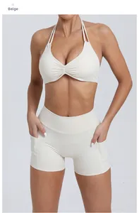 Detailed front view of creamy yellow yoga set with halter bra and high-waist pocket shorts
