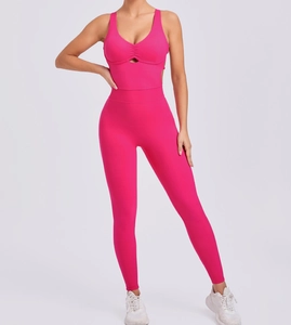 Detailed view of rose red yoga jumpsuit featuring V-neck cutout and front pleated texture
