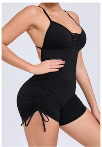 Detail view of black yoga bodysuit with side drawstrings and backless cutout design