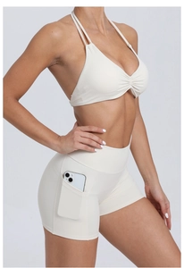 Close-up of cream yoga shorts featuring a functional side pocket for mobile phones