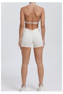 Detail view of high-waisted yoga shorts with V-shaped seam for lifting effect in beige