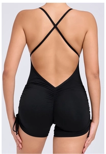 Detailed back view of a black yoga romper featuring a deep V cut and ruched butt lifting seam